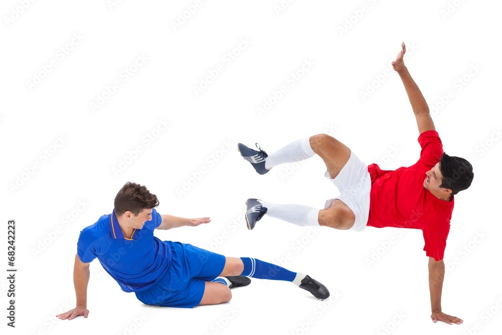 Football players tackling for the ball Football players tackling for the ball