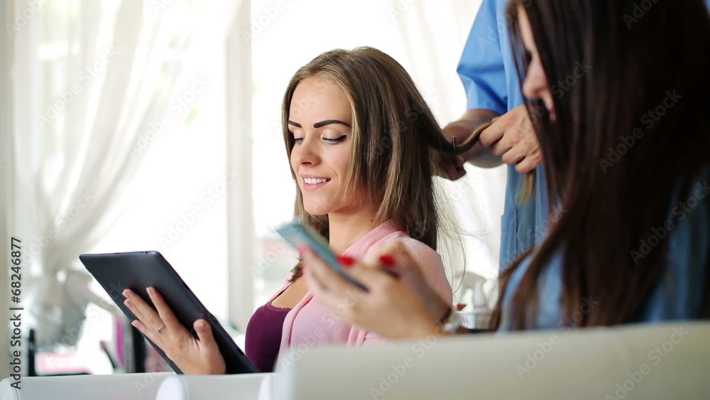 Girlfriends watch funny things on tablet and smartphone Girlfriends watch funny things on tablet and smartphone