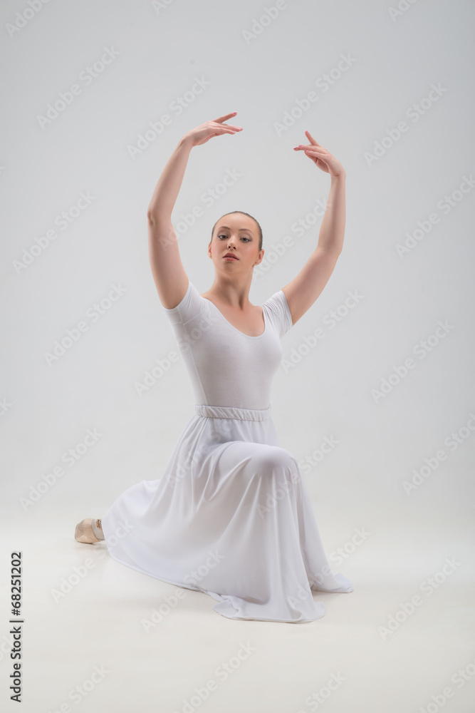 Naklejka premium Young and beautiful ballet dancer posing isolated