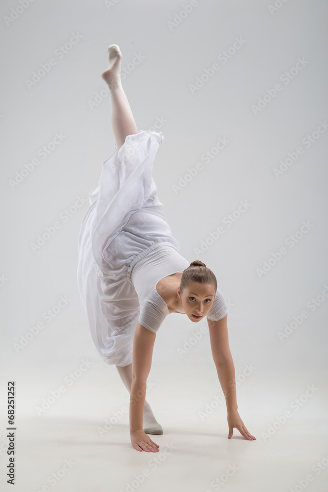 Naklejka premium Young and beautiful ballet dancer posing isolated