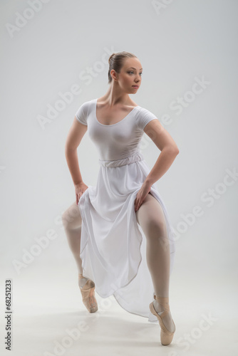 Young and beautiful ballet dancer posing isolated © zinkevych