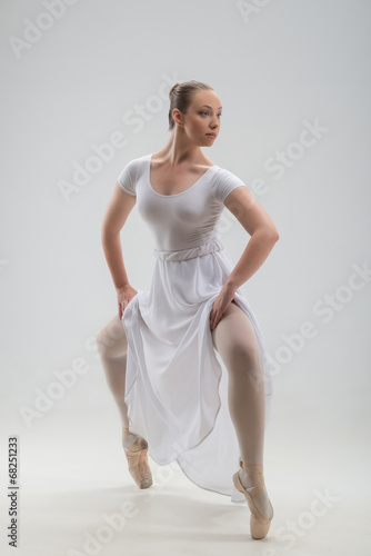 Young and beautiful ballet dancer posing isolated