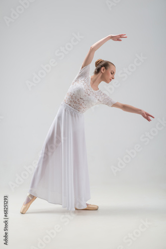 Young and beautiful ballet dancer posing isolated