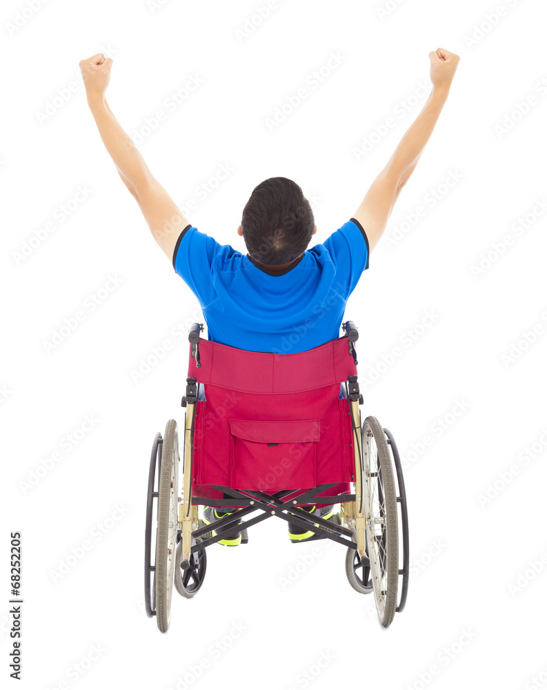 handicapped man sitting on a wheelchair and raise arms handicapped man sitting on a wheelchair and raise arms