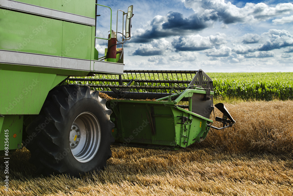 Combine harvester in action on wheat field Combine harvester in action on wheat field