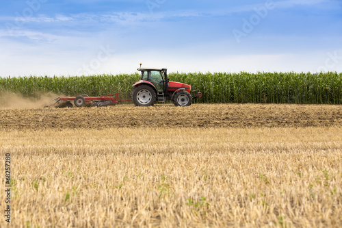 Tractor cultivating wheat stubble field  crop residue.