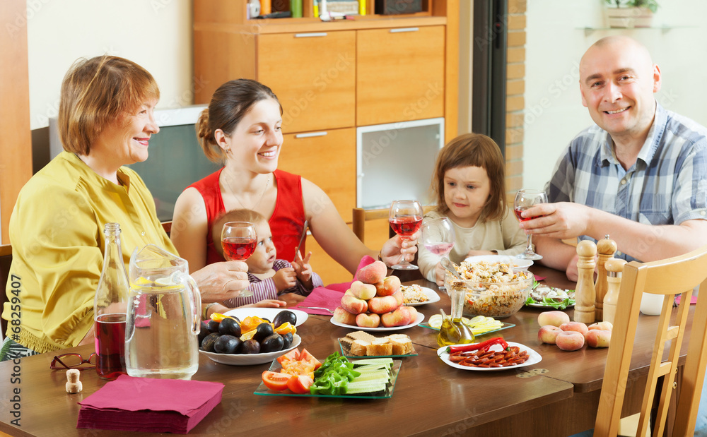 happy multigeneration family  around festive table