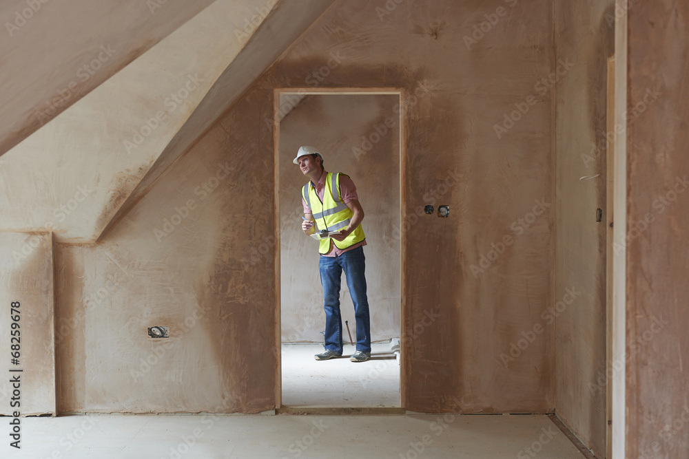 Building Inspector Looking At New Property