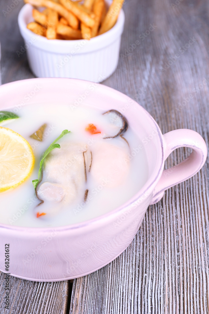 Tasty soup with oysters on wooden table Tasty soup with oysters on wooden table