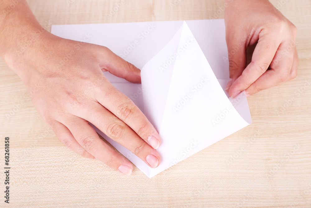 Hands making origami figure, close up Hands making origami figure, close up