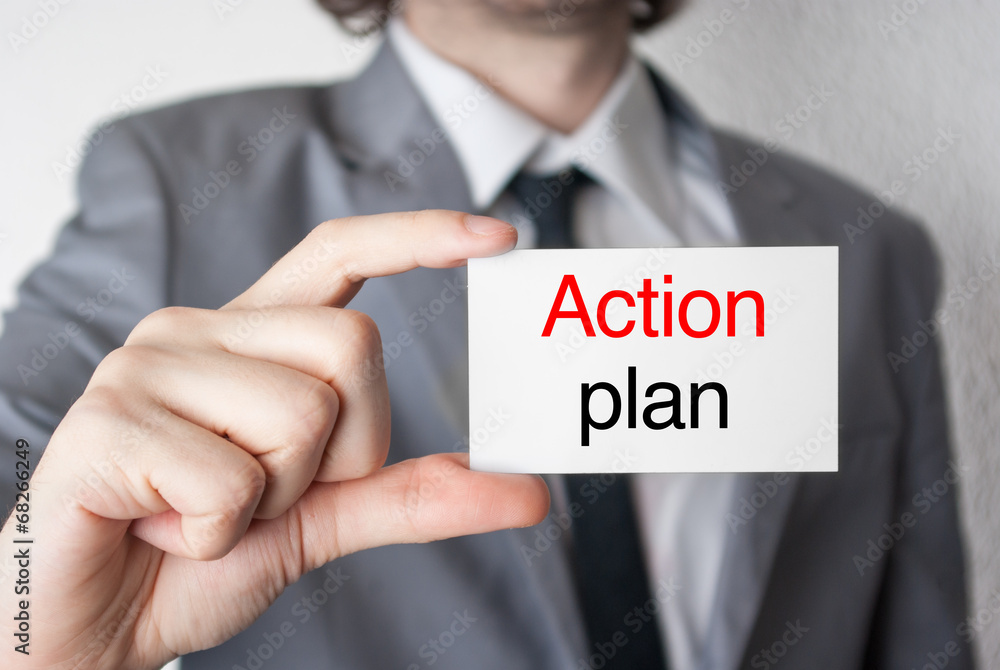 Action plan. Businessman showing business card Action plan. Businessman showing business card