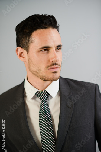 isolated portrait of handsome young businessman on trendy suit