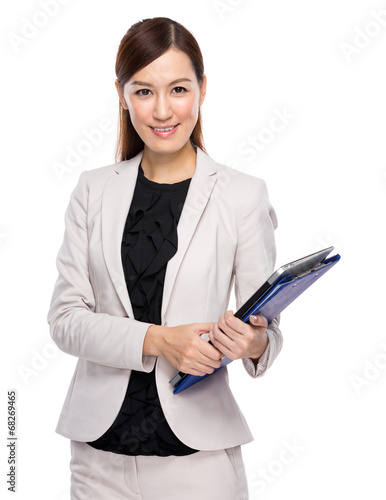 Businesswoman hold clipboard and laptop © leungchopan