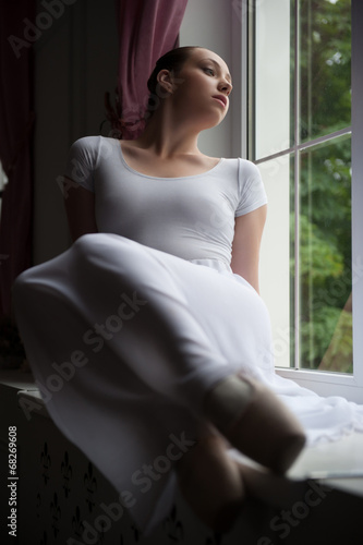 Ballerina sitting on windowsill