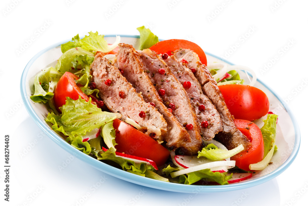 Grilled meat and vegetables on white background