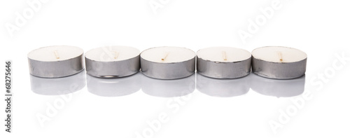 Small tealights over white background photo