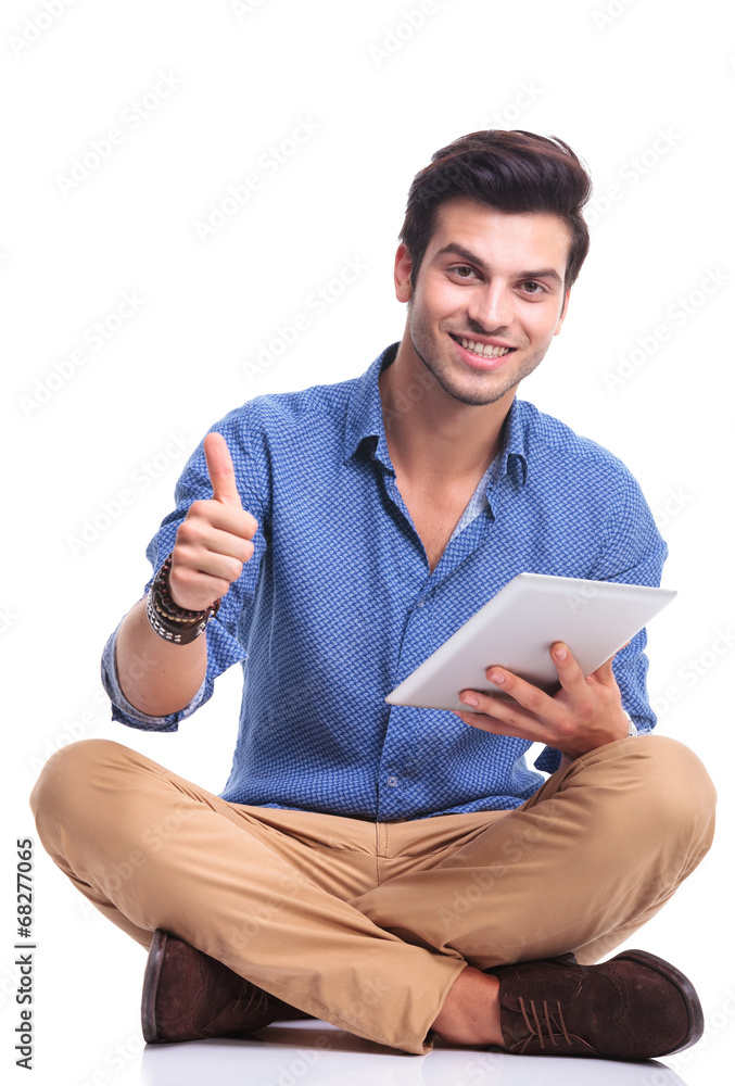 casual man with tablet pad computer making the ok sign casual man with tablet pad computer making the ok sign