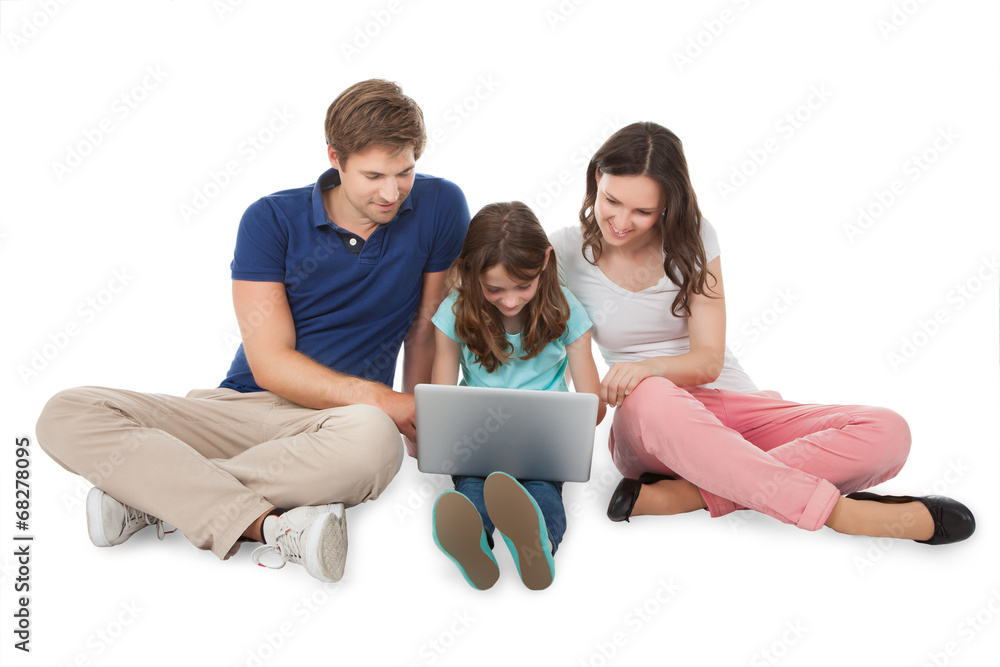 Family Sitting With Laptop Over White Background Family Sitting With Laptop Over White Background