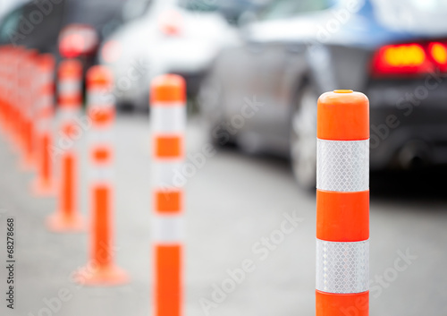 Foto Orange bollard on the road. Traffic jam.