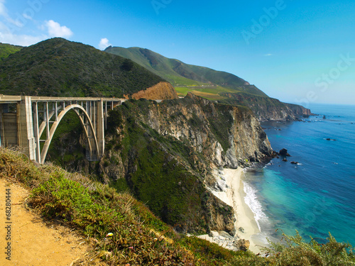 Bridge on Pacific rocky coast of California photo