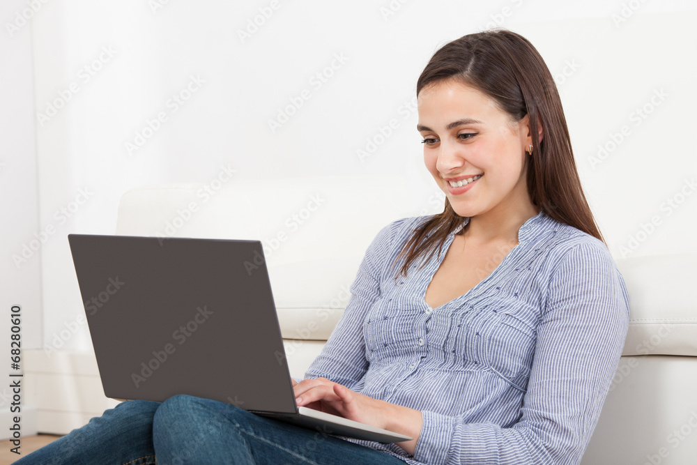 Smiling Woman Using Laptop In House Smiling Woman Using Laptop In House