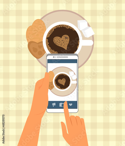 Human is photographing his cup of coffee  in restaurant