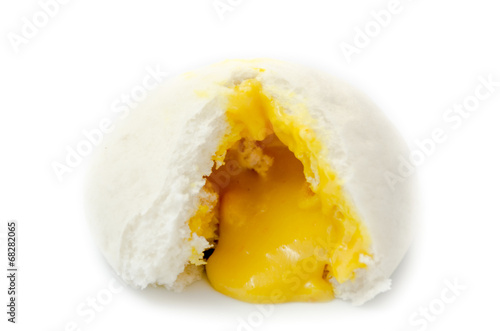 Chinese steamed bun show its yellow cream isolated on white back