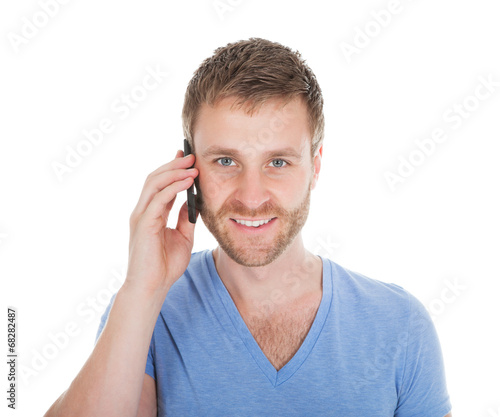 Happy Man Answering Cell Phone While Looking Away