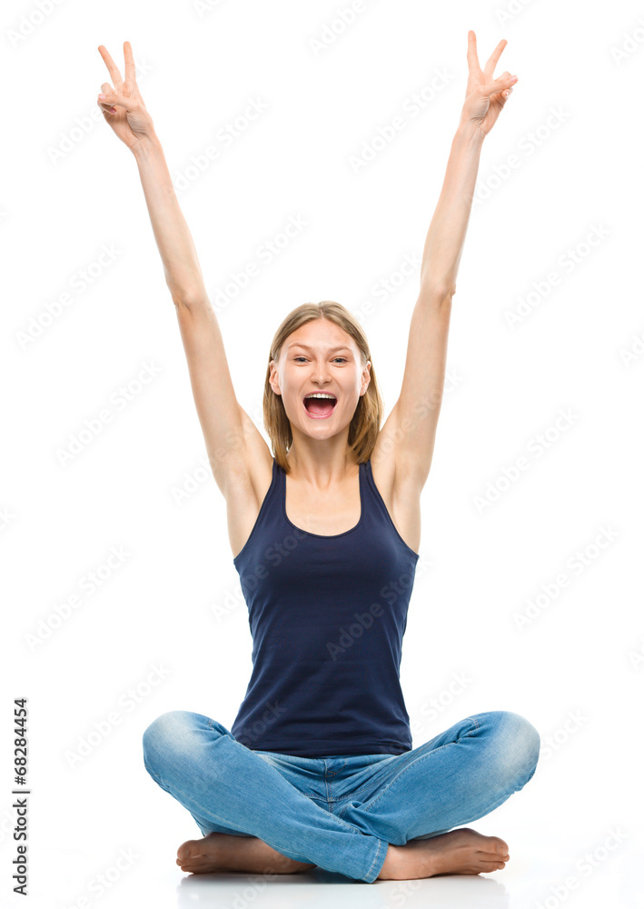 Young happy woman is sitting on the floor Young happy woman is sitting on the floor