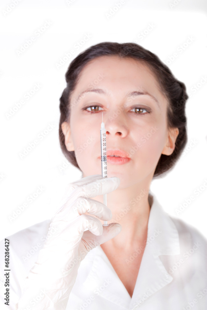 Female nurse checking empty syringe Female nurse checking empty syringe