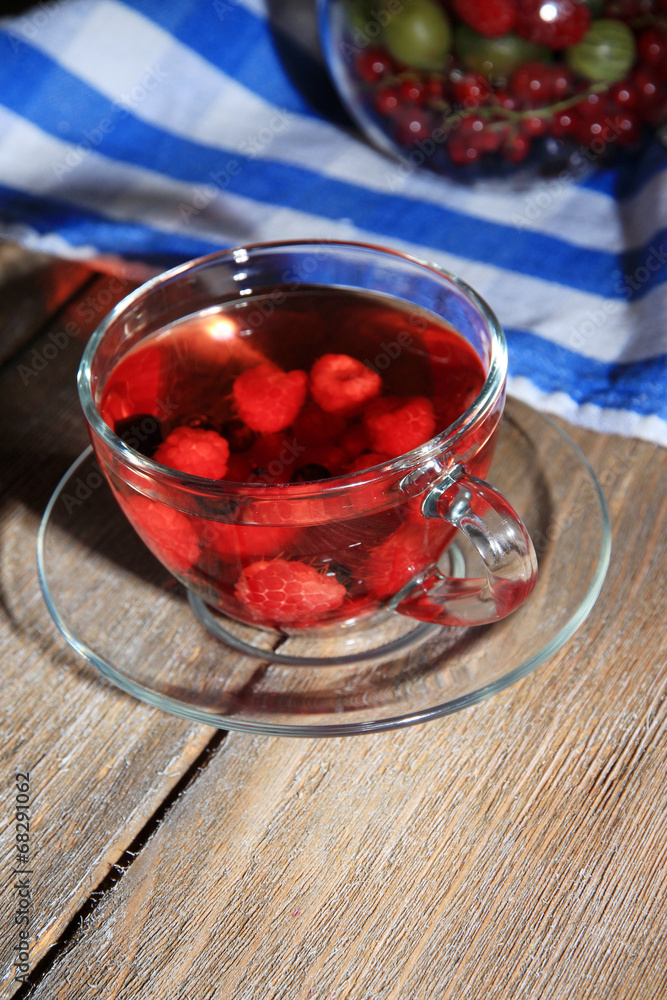 Fruit red tea with wild berries in glass cup,