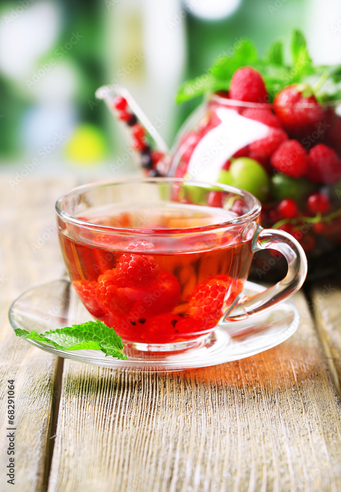 Fruit red tea with wild berries in glass cup,