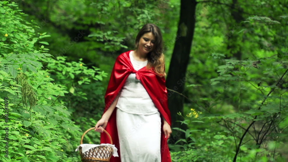 Happy Red riding hood with basket walking in forest, slow motion Happy Red riding hood with basket walking in forest, slow motion