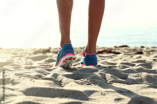 woman running on the beach. closeup on shoe.