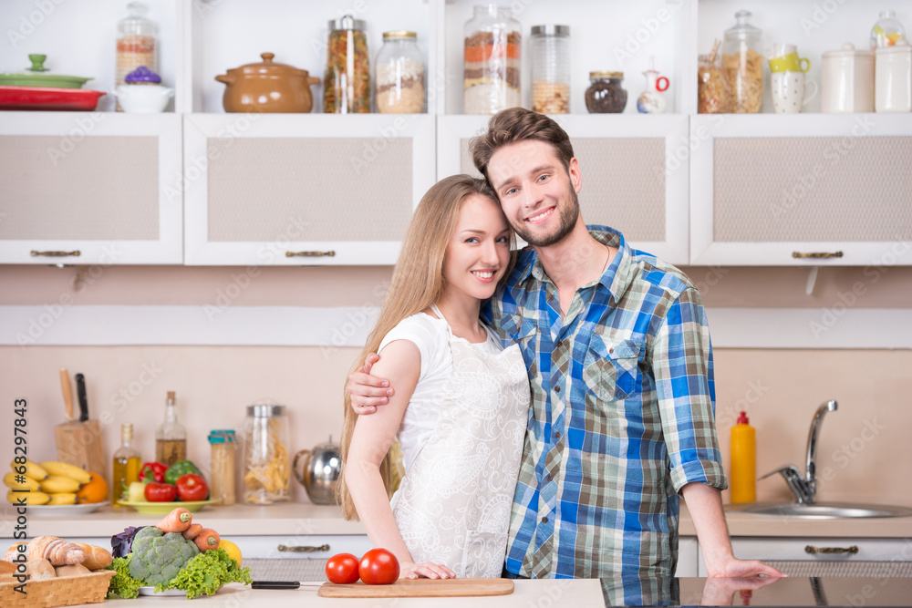 Portrait of a happy young couple at kitchen Portrait of a happy young couple at kitchen