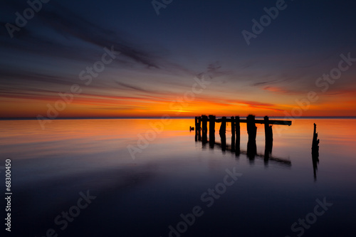 Wooden poles on the lake at sunrise