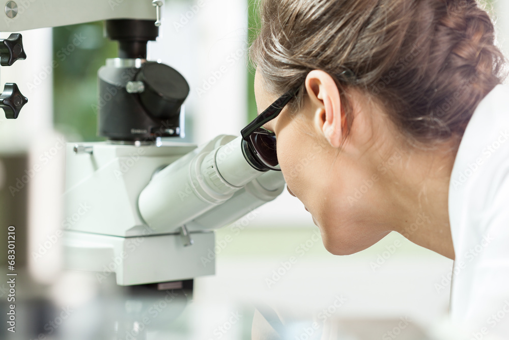 Woman working with microscope Woman working with microscope