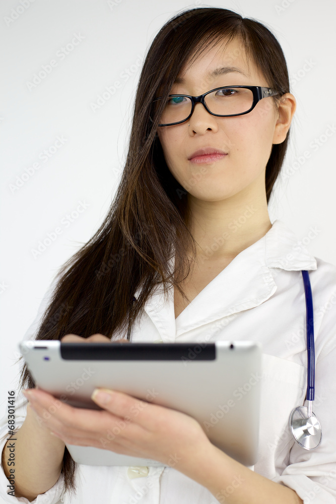 Young asian female doctor working with tablet