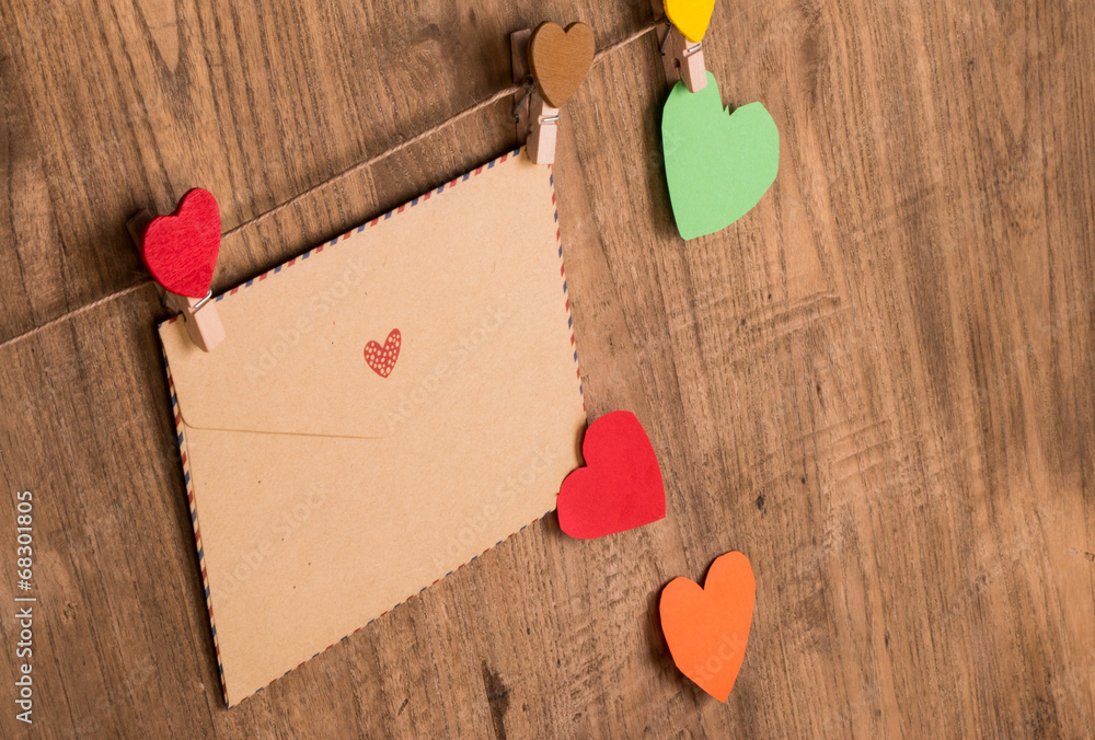 envelope and paper heart hanging on wooden background envelope and paper heart hanging on wooden background