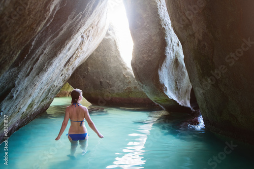 Photography Young girl at cave on tropical beach