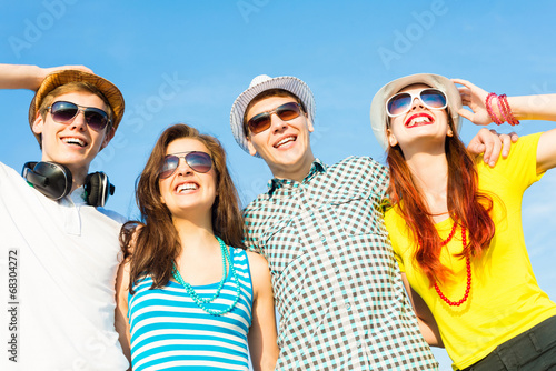 group of young people wearing sunglasses and hat