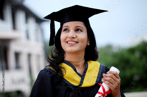 Young female student with diploma at outdoors