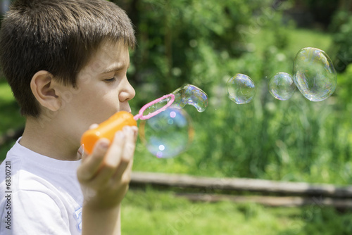 Child makes bubbles