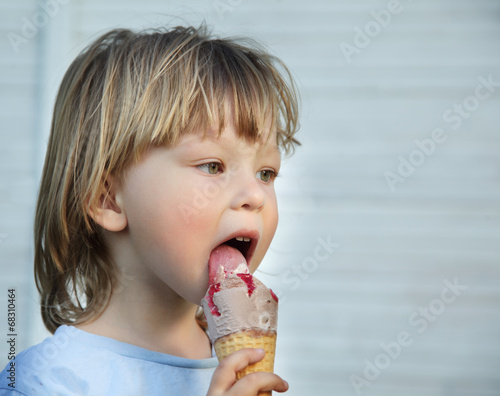 happy little boy eating an ice cream