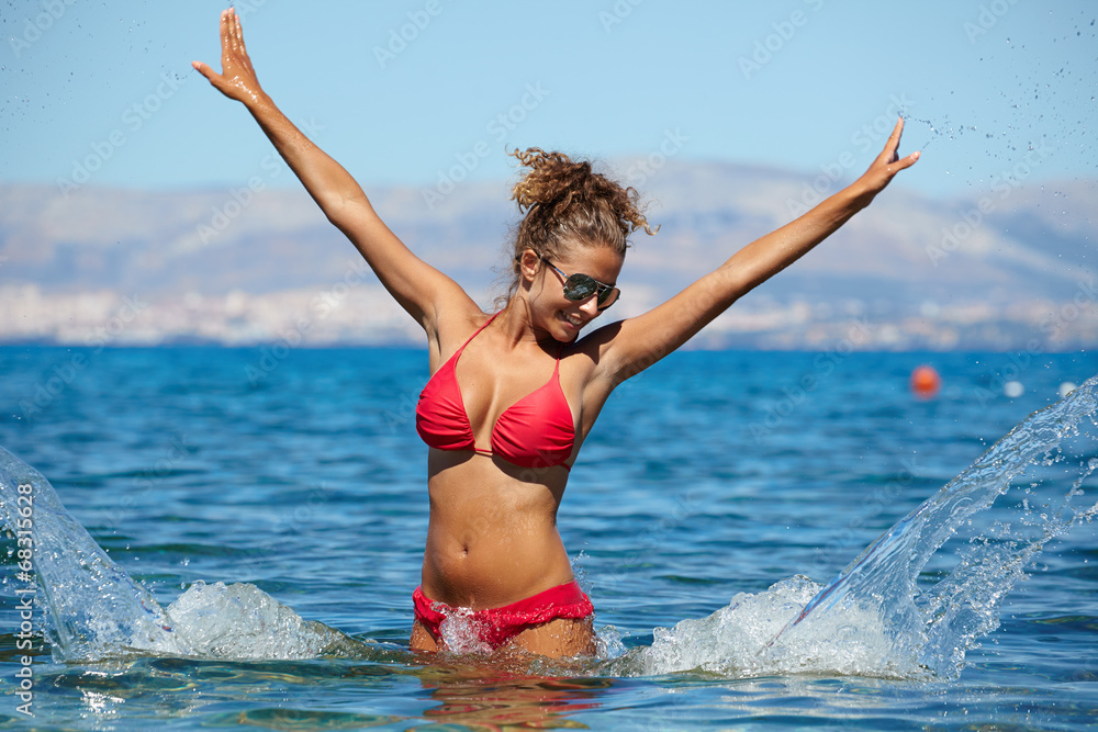 Beautiful bikini model splashing water Beautiful bikini model splashing water