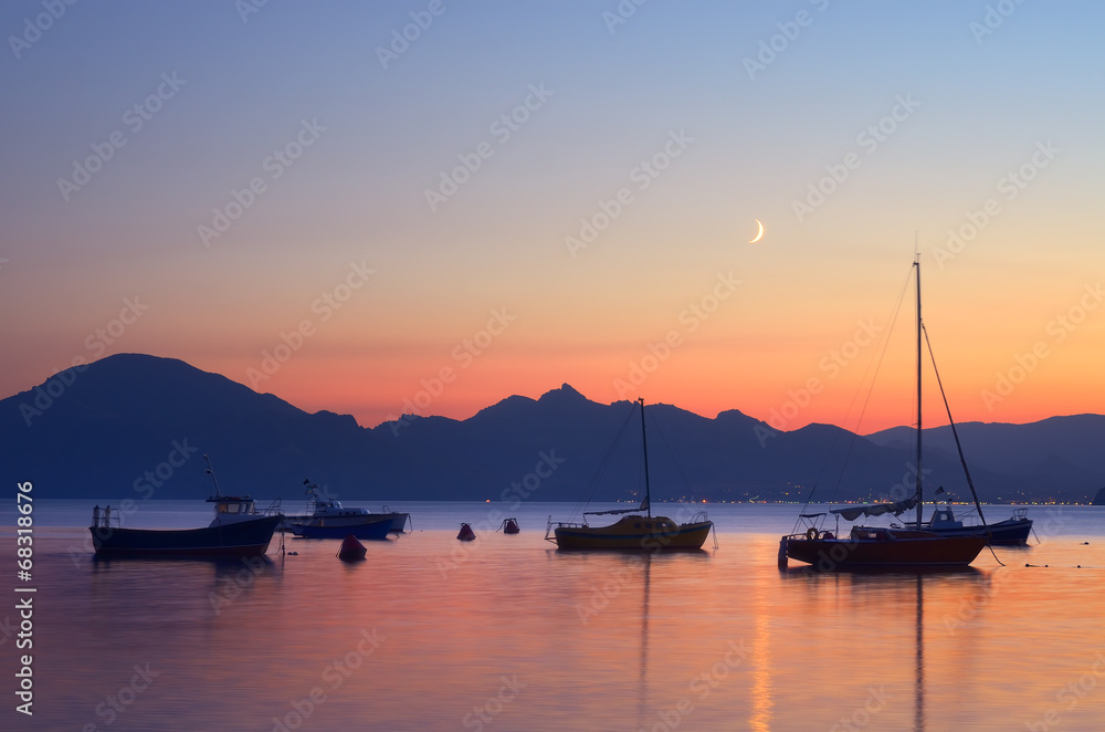 Boats in the sea at night