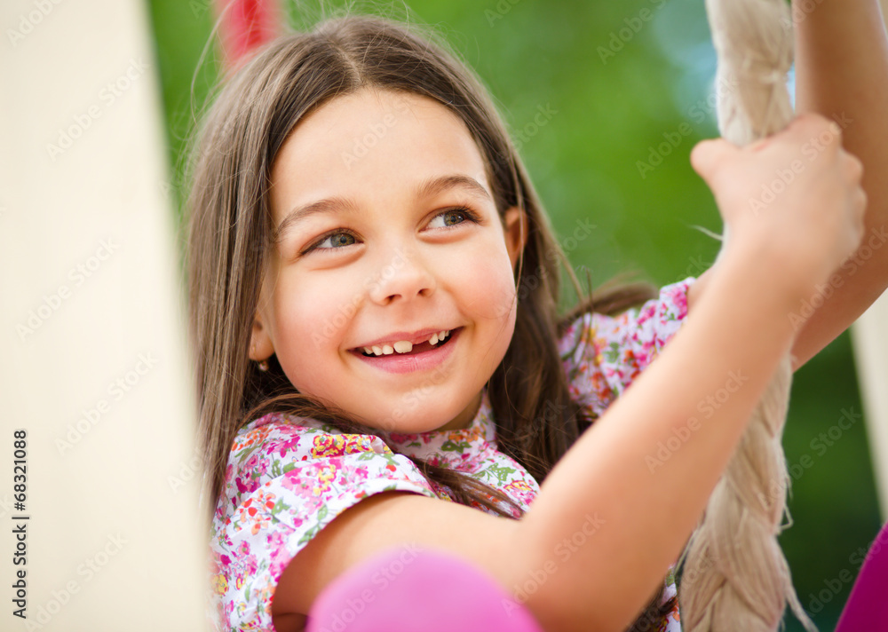 Cute little girl is playing in playground Stock Photo | Adobe Stock