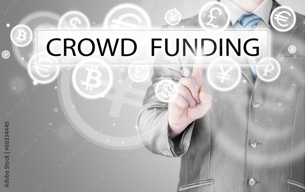 Businessman pushes virtual crowd funding button Businessman pushes virtual crowd funding button