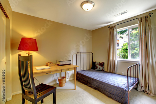 Bedroom with antique iron frame bed and desk