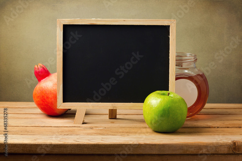 Chalkboard with honey and apple for Jewish New Year Holiday